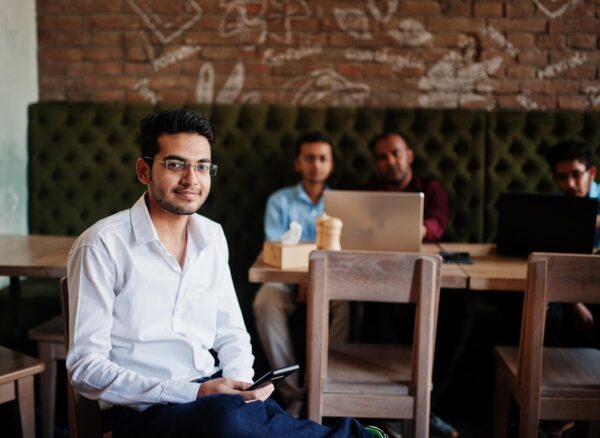 group-four-south-asian-men-s-posed-business-meeting-cafe-indians-work-with-laptops-together-using-various-gadgets-having-conversation-indian-man-with-mobile-phone_627829-5227