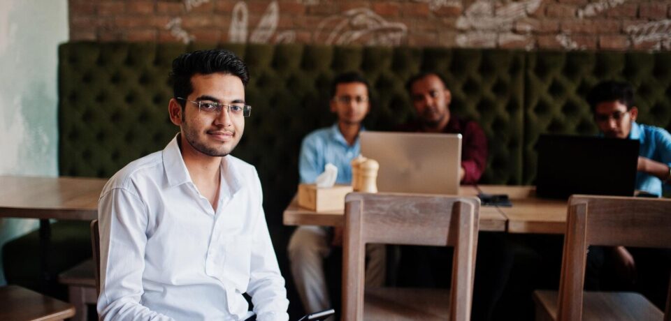 group-four-south-asian-men-s-posed-business-meeting-cafe-indians-work-with-laptops-together-using-various-gadgets-having-conversation-indian-man-with-mobile-phone_627829-5227