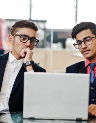 two-indian-business-man-suits-sitting-office-cafe-looking-laptop_627829-1473