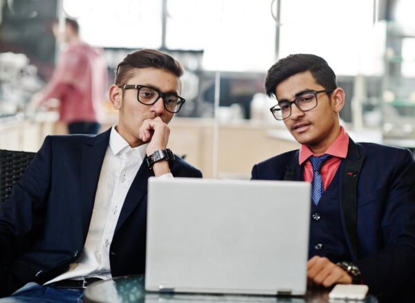 two-indian-business-man-suits-sitting-office-cafe-looking-laptop_627829-1473